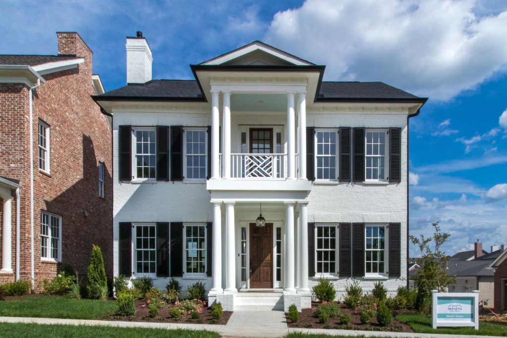 A white two story home in stephens valley with large white pillars