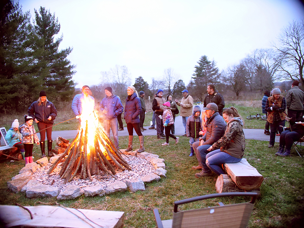 A community gathering around a bonfire in stephens valley