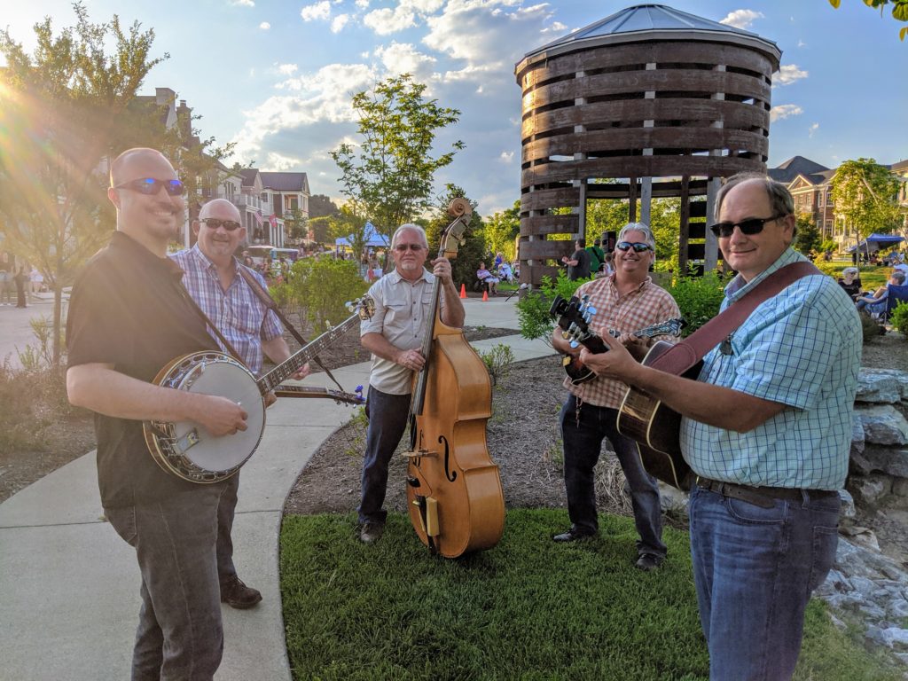 A bluegrass band posing for a photo
