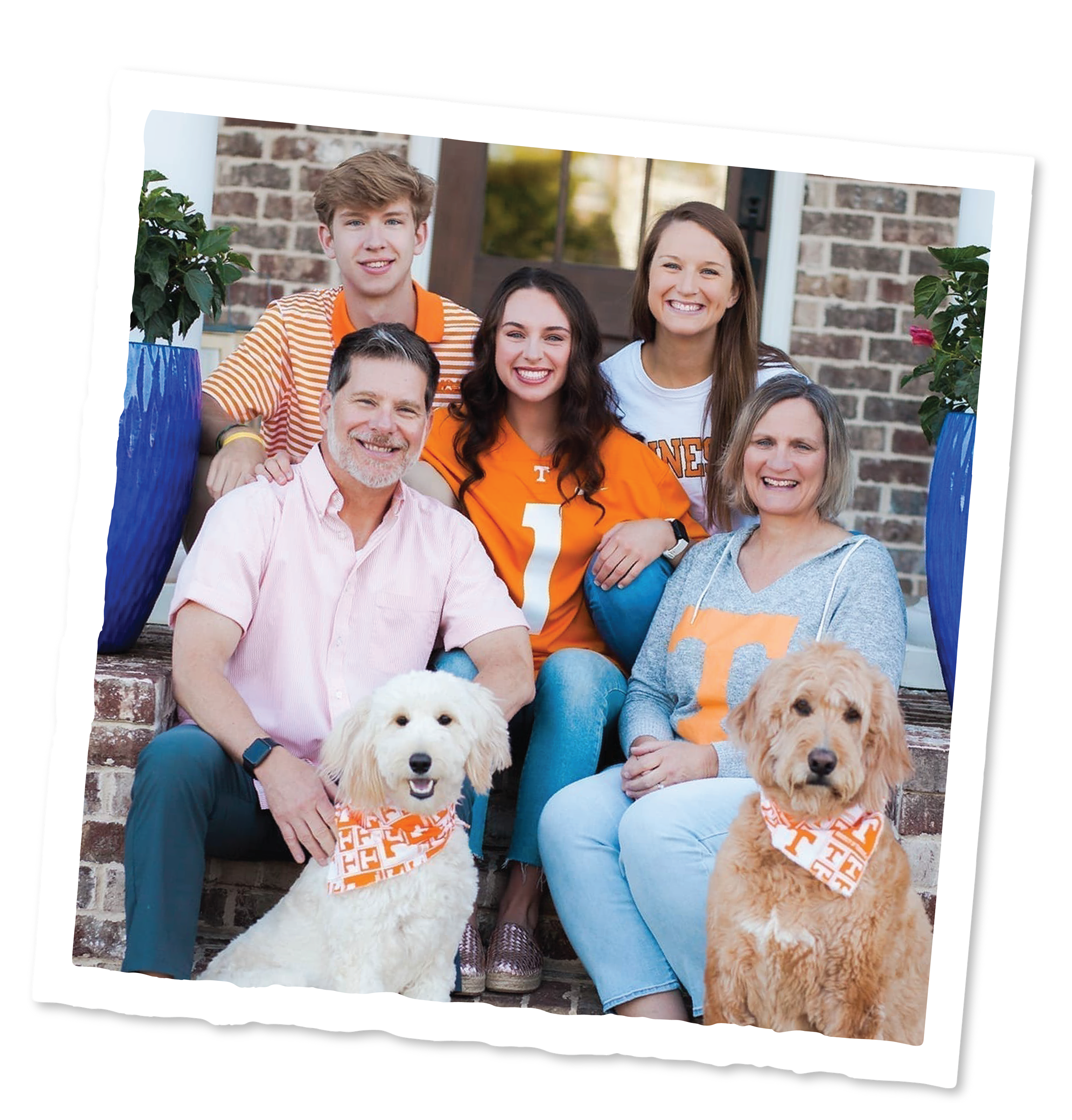 A family of five with two dogs