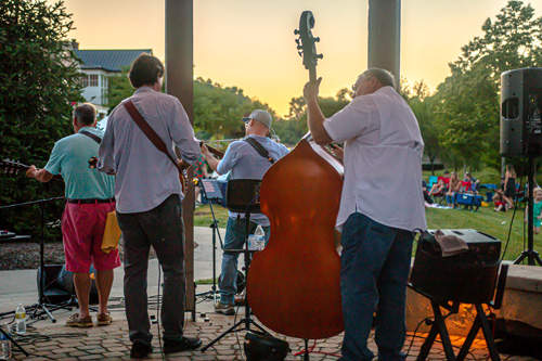 A bluegrass band playing at dusk