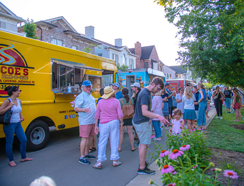 A group of people gathered in front of a food truck