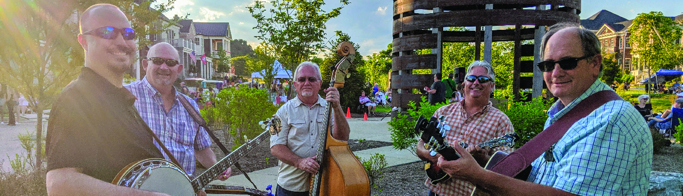 A bluegrass band posing for a photo