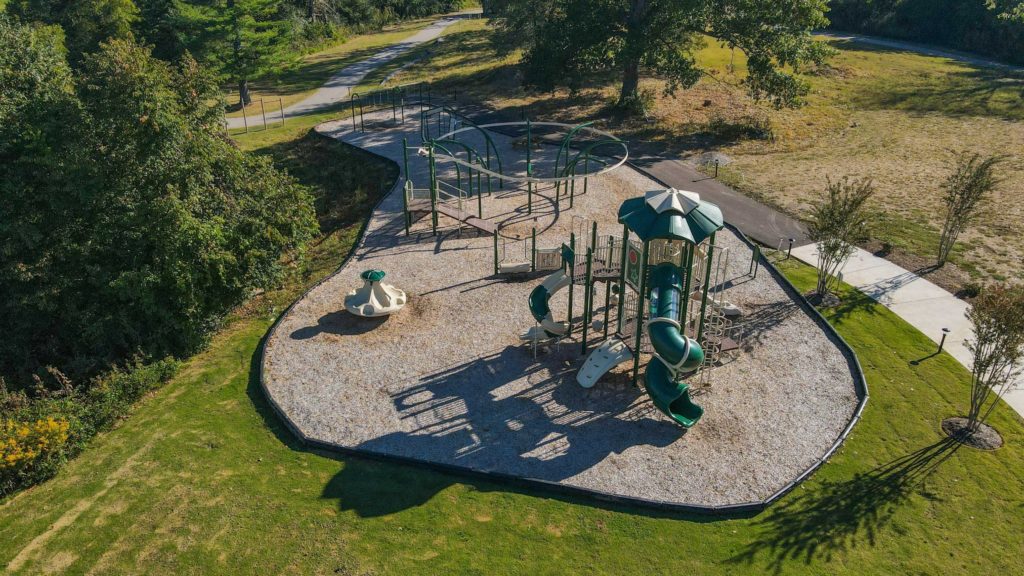 An overhead shot of a playground in stephens valley with a green slide