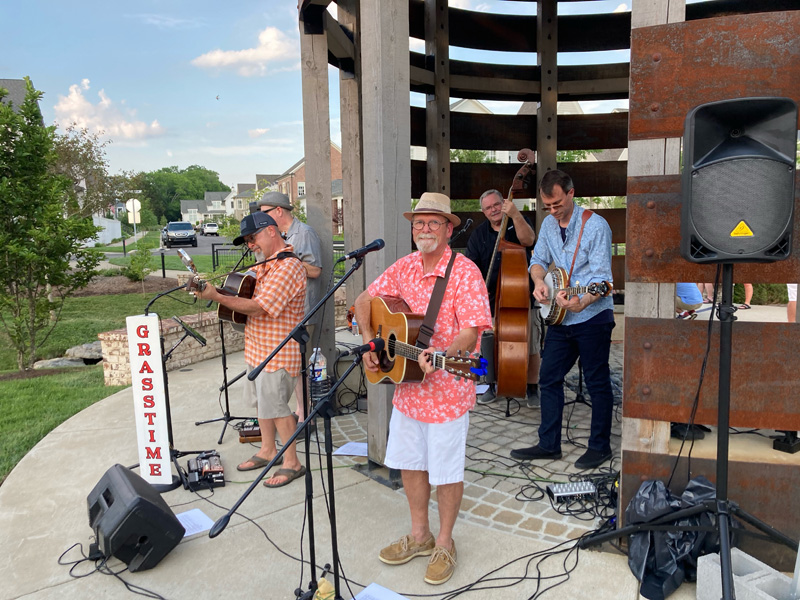 A bluegrass band setting up to play