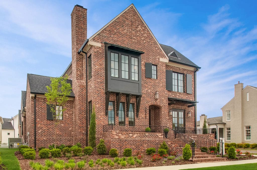 A two story brick home and front lawn in stephens valley