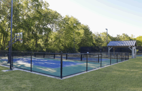 The tennis courts at stephens valley with trees in the background